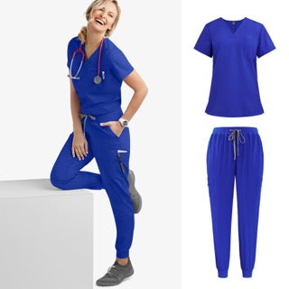 A smiling female healthcare professional wearing a royal blue short-sleeved V-neck scrub top and matching jogger scrub pants, showcasing the comfort and style of modern medical uniforms.